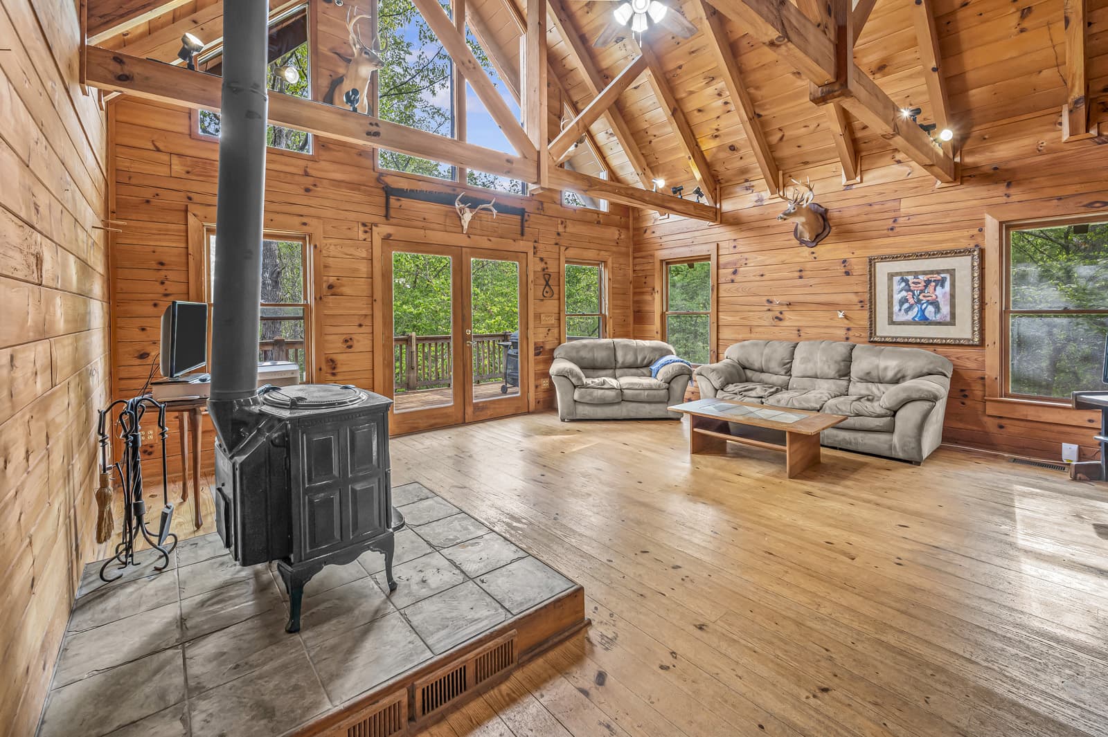 log cabin interior with wood stove and large windows