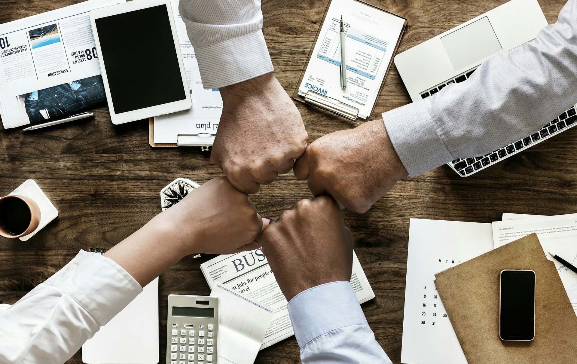 team members fist bumping